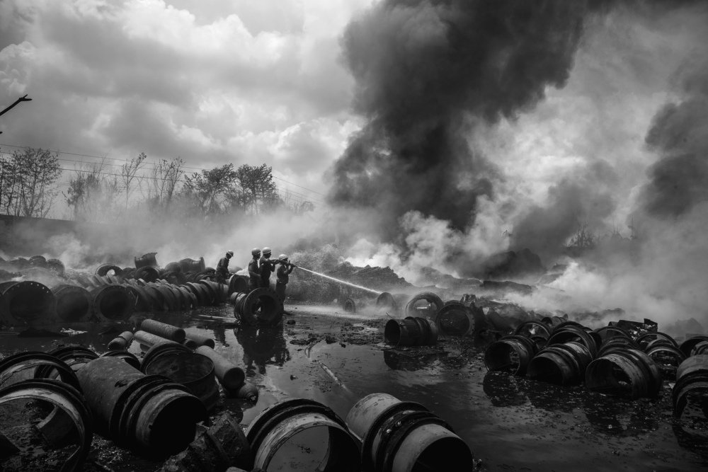 Men under smoke clouds.