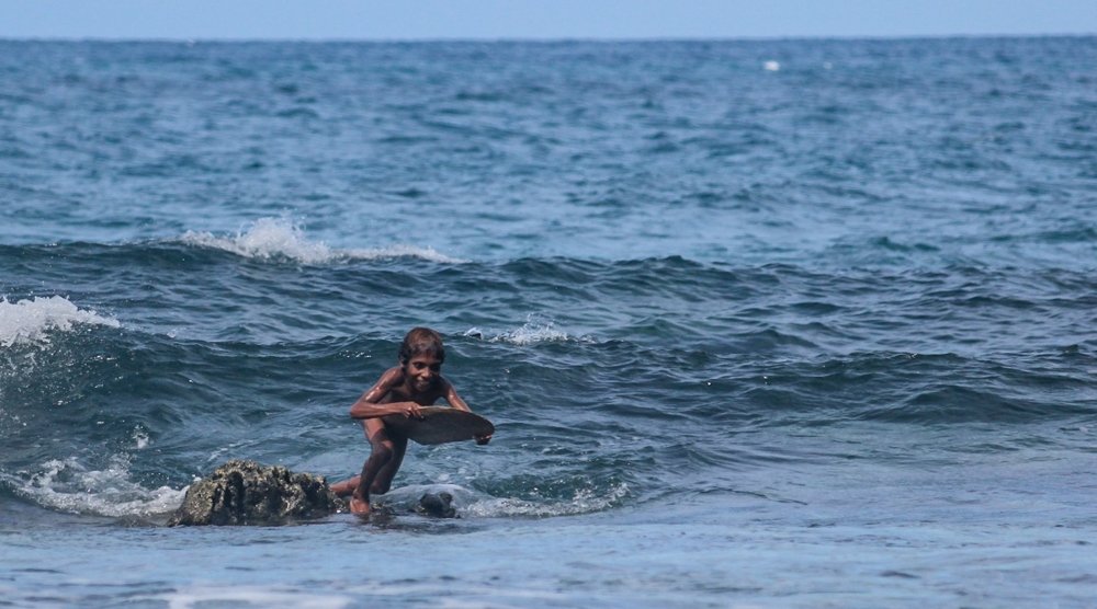 A Wooden Sliding board in the style of a Papuan child