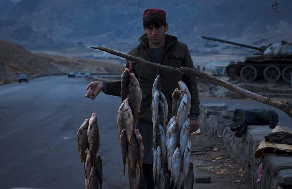 A young fishseller on kabul highway, afghansitan