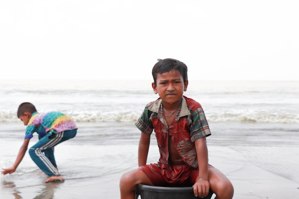 son of fisherman set in a backet .