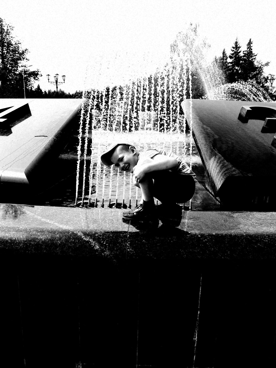 Happy boy near the fountain