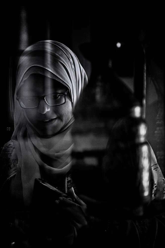 Woman behind glass in a Museum