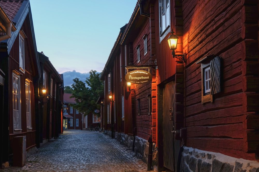 A street in the center of Västerås, with traditional red wooden houses.