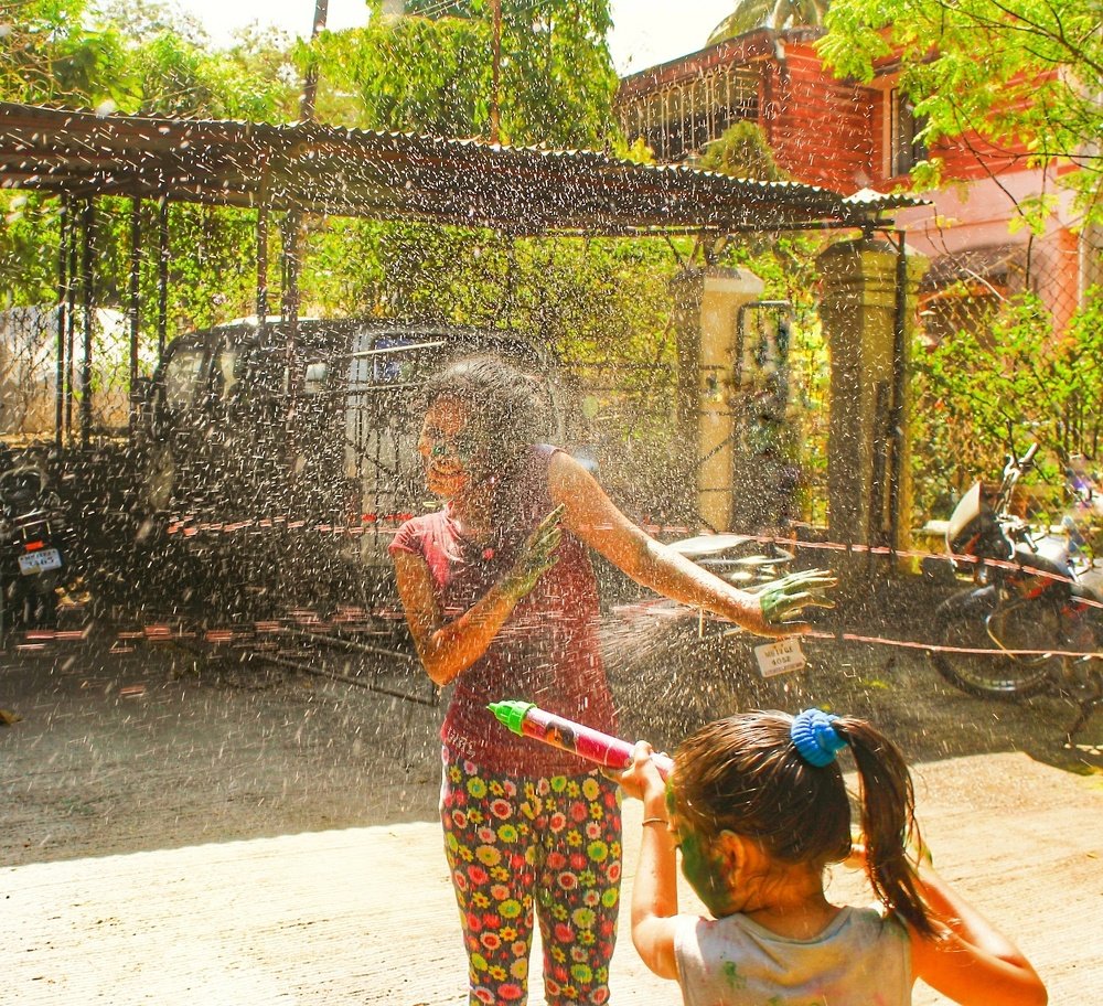 Water sprinkles on Girl at the time of Rangpanchami festival