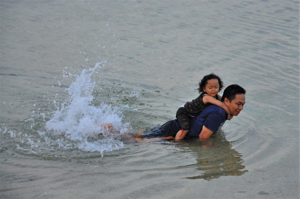 Carrying a child on the beach