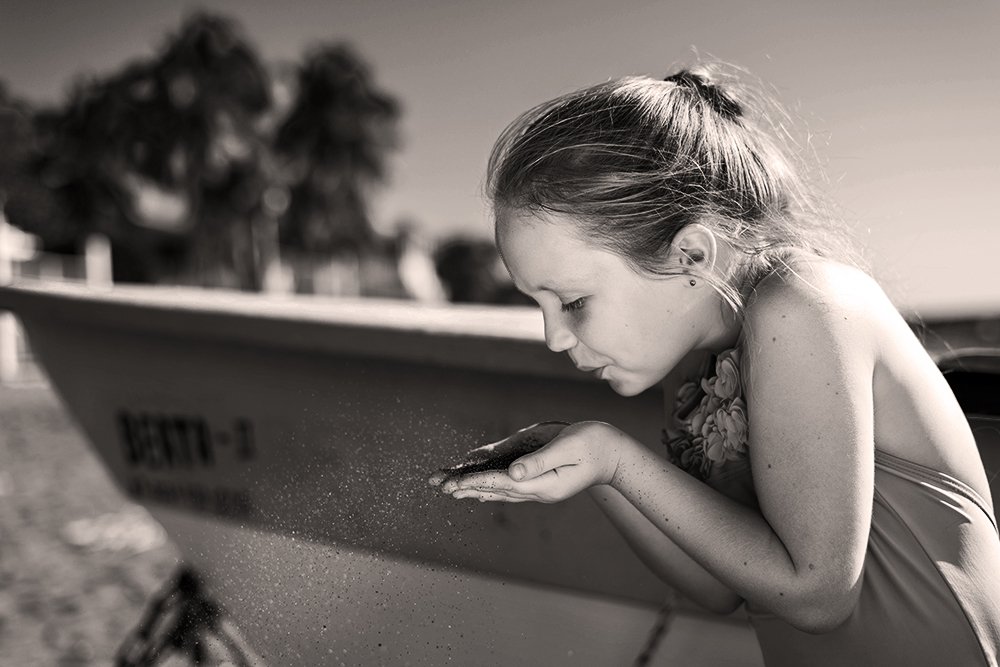 Blowing the sand on the beach