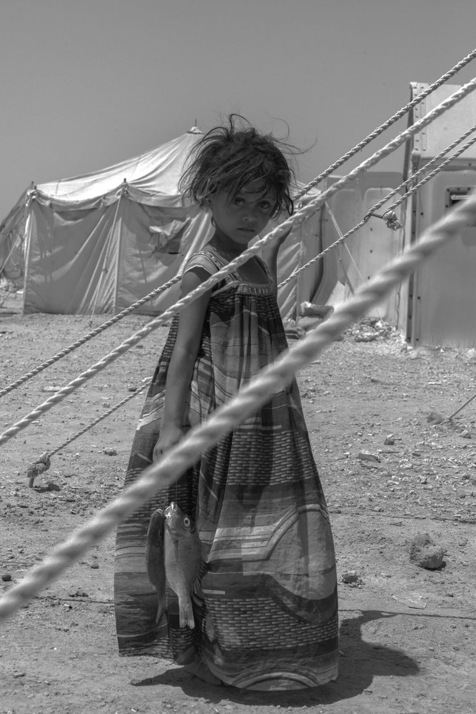The girl with the fish in the refugee camp