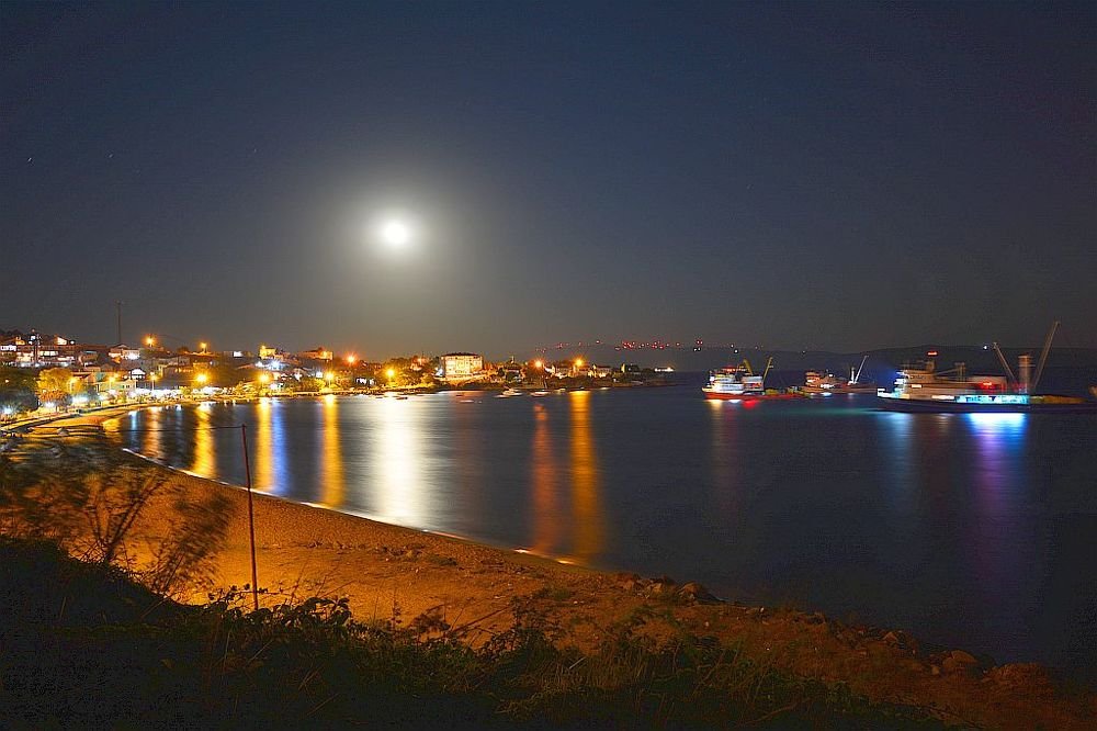 boats, sea and moon rising