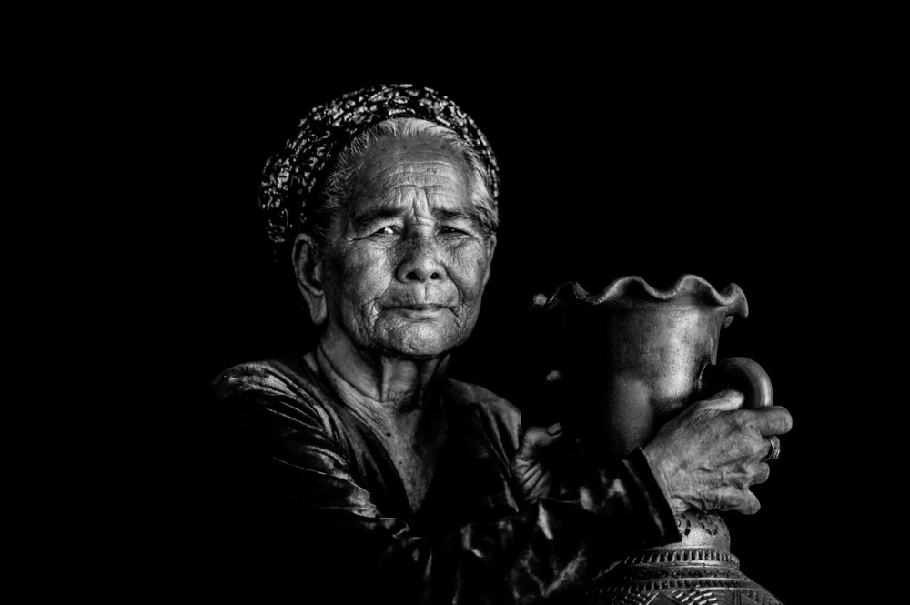 Grandma selling pottery