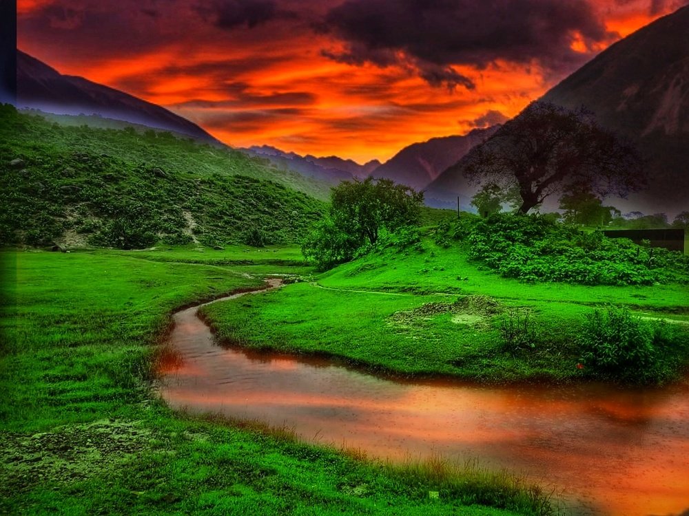 A reflect of red sky throughout the mountains  on lake