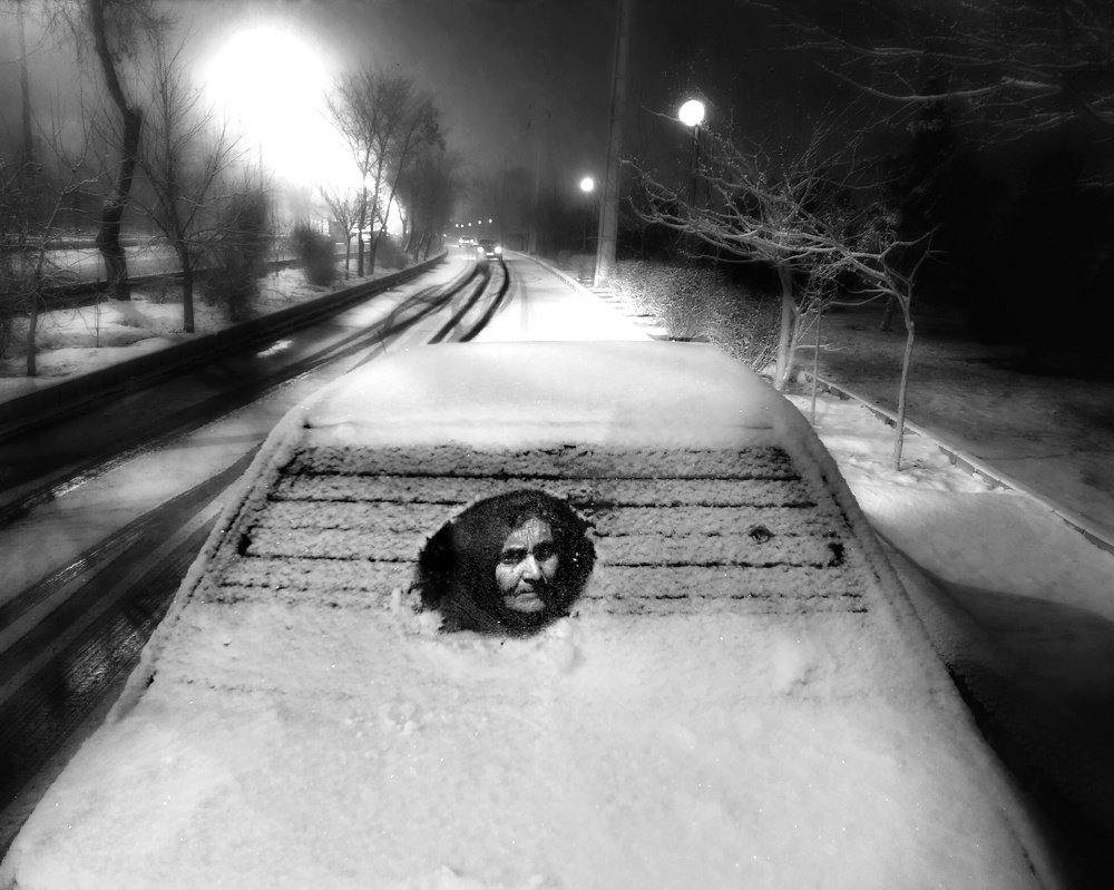 an old man portrait behind the car mirror