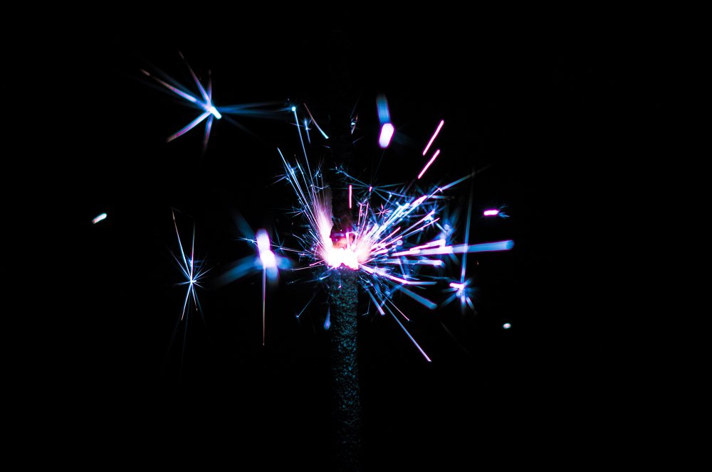 Sparklers in different colors on a black background