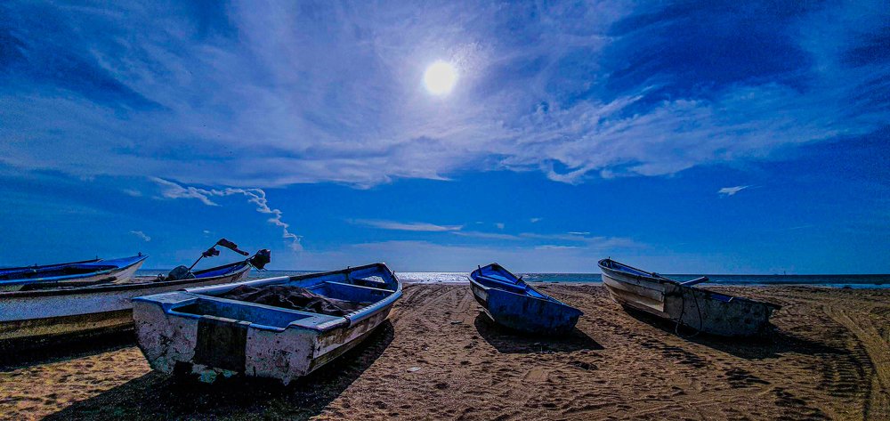 Fishing Boats Contrasted With Blue Skies