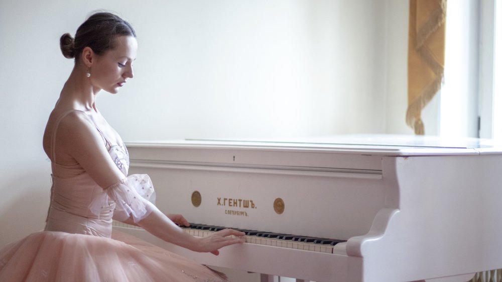 Fairy doll ballerina playing old Russian piano