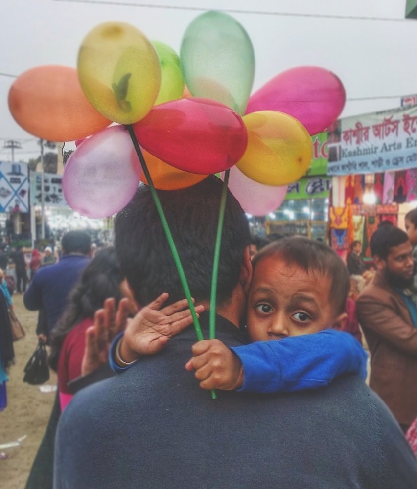 I wander the fair at my father's lap..