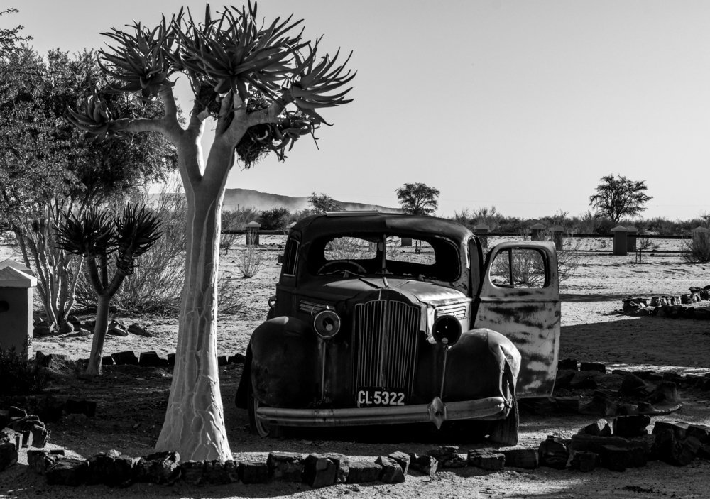 Old abandoned car in the middle of the desert