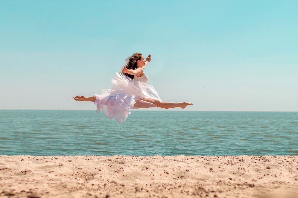 Шпагат в воздухе на берегу моря