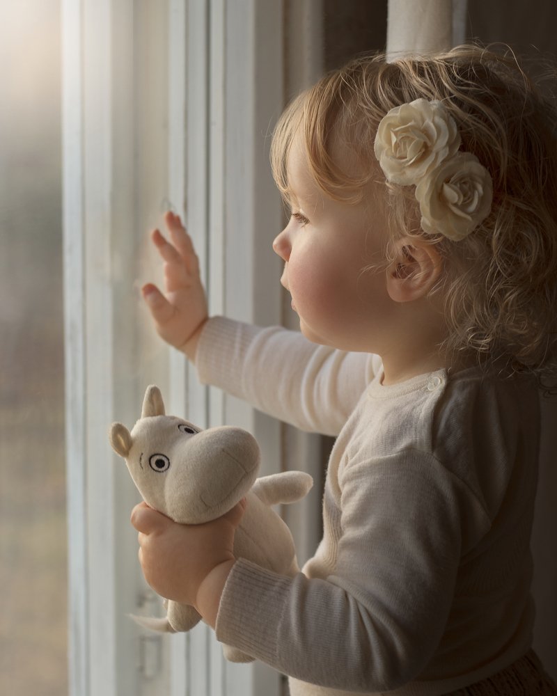 Girl portrait beside window