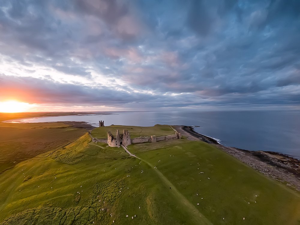 Dunstanburgh Castle at sunset. Northumberland. UK