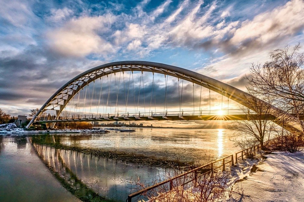 Morning sunlight beams through the bridge