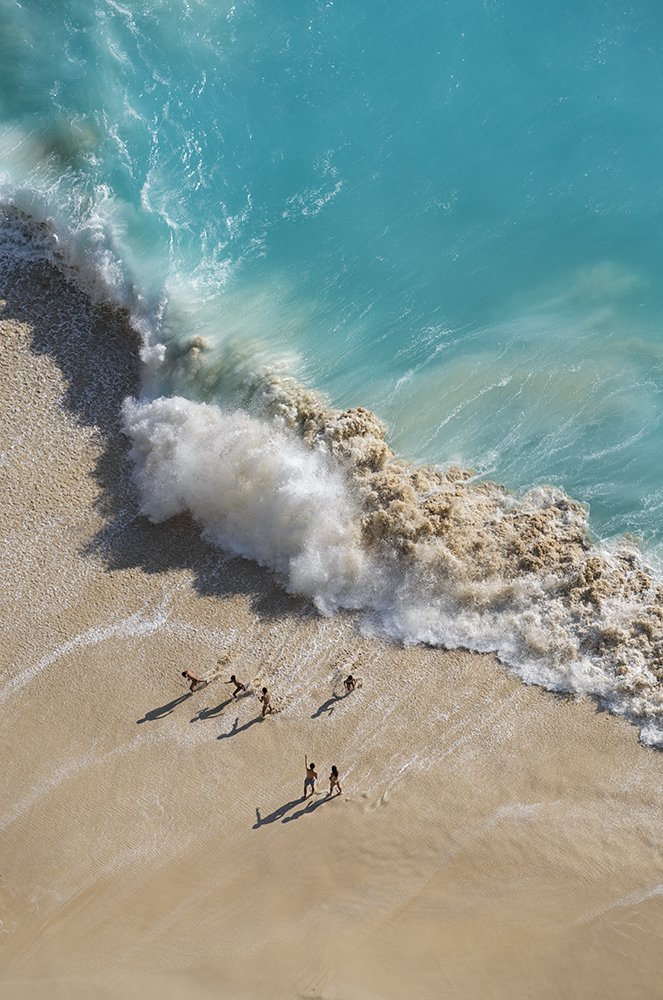 Kids playing against the waves