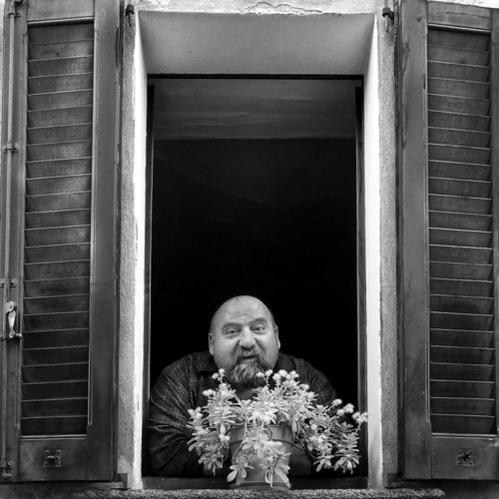 Man and flowers at the window