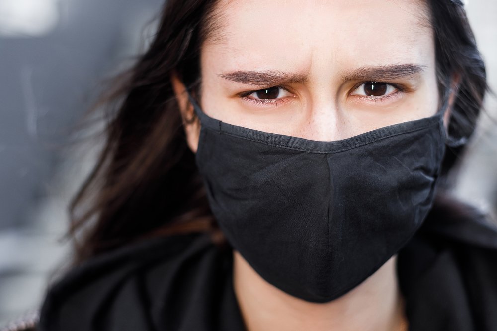 Woman in a black masque against of COVID-19