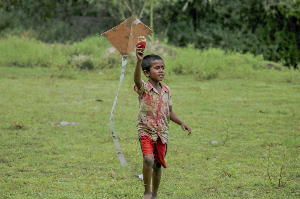 this boy is playing with kiteà