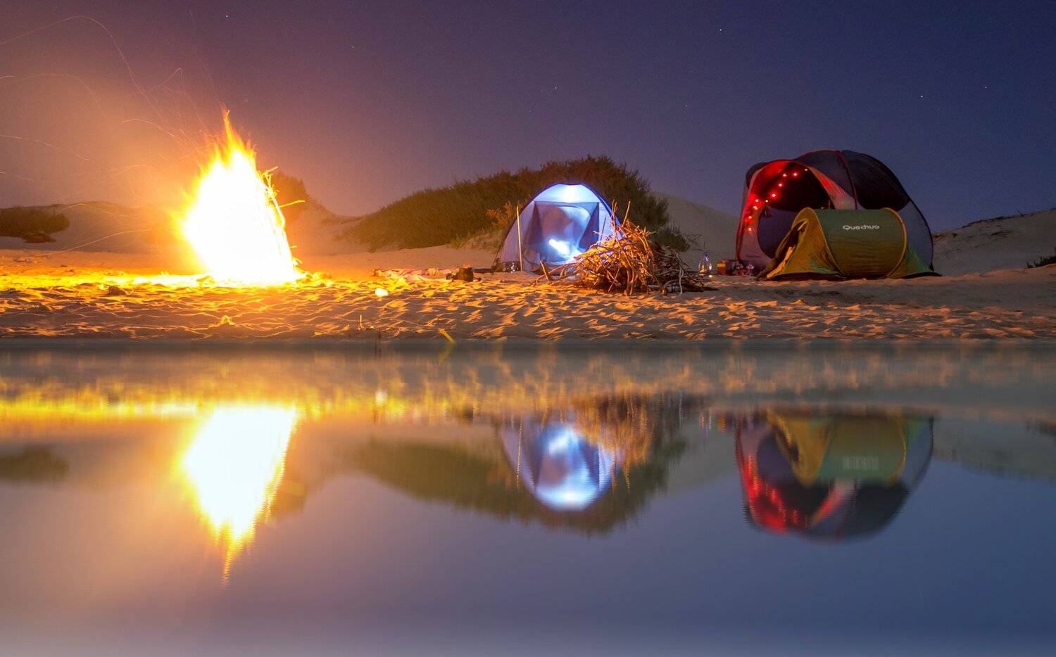 Firecamp reflection on water