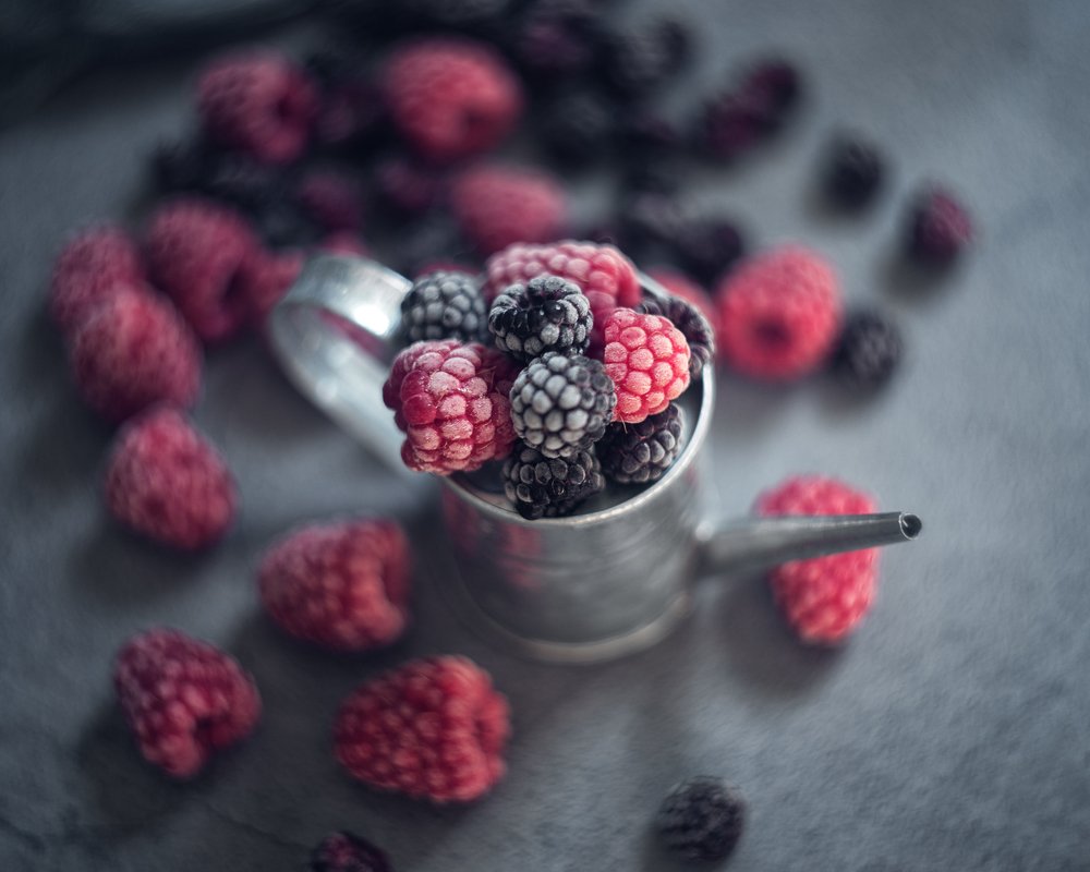 Raspberries and blackberries in tin can