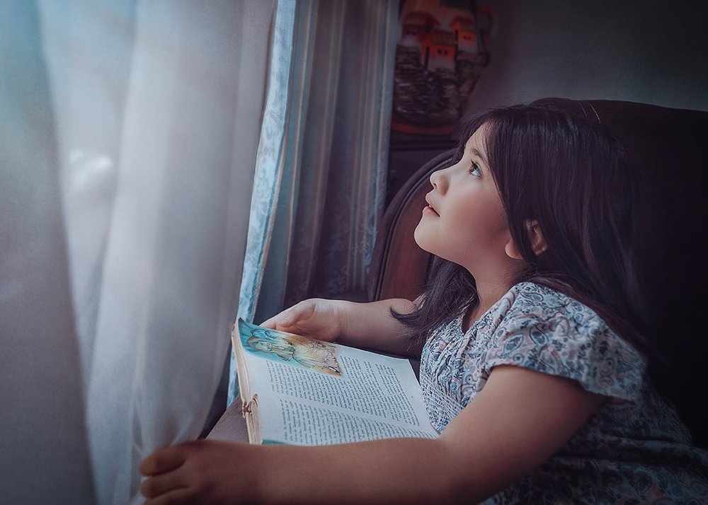 Reading a book by the window