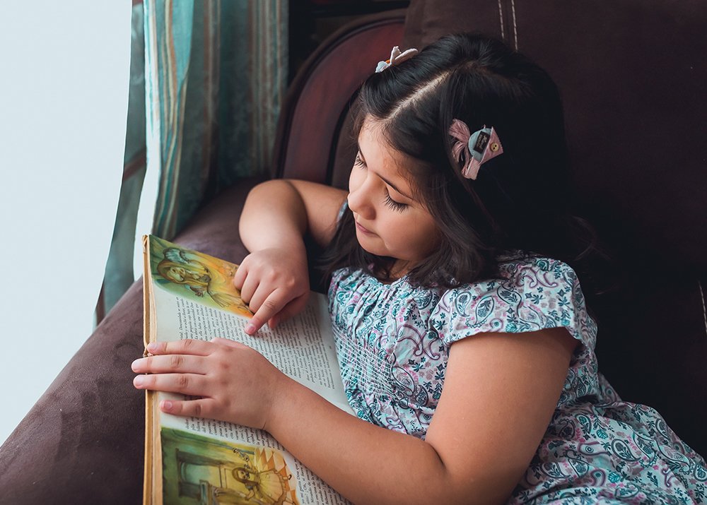 Reading a book by the window