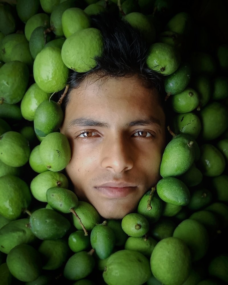 Man Burried Under Raw Mango