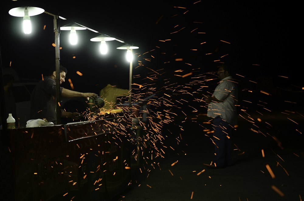 Corn cobs being roasted on a coal fire
