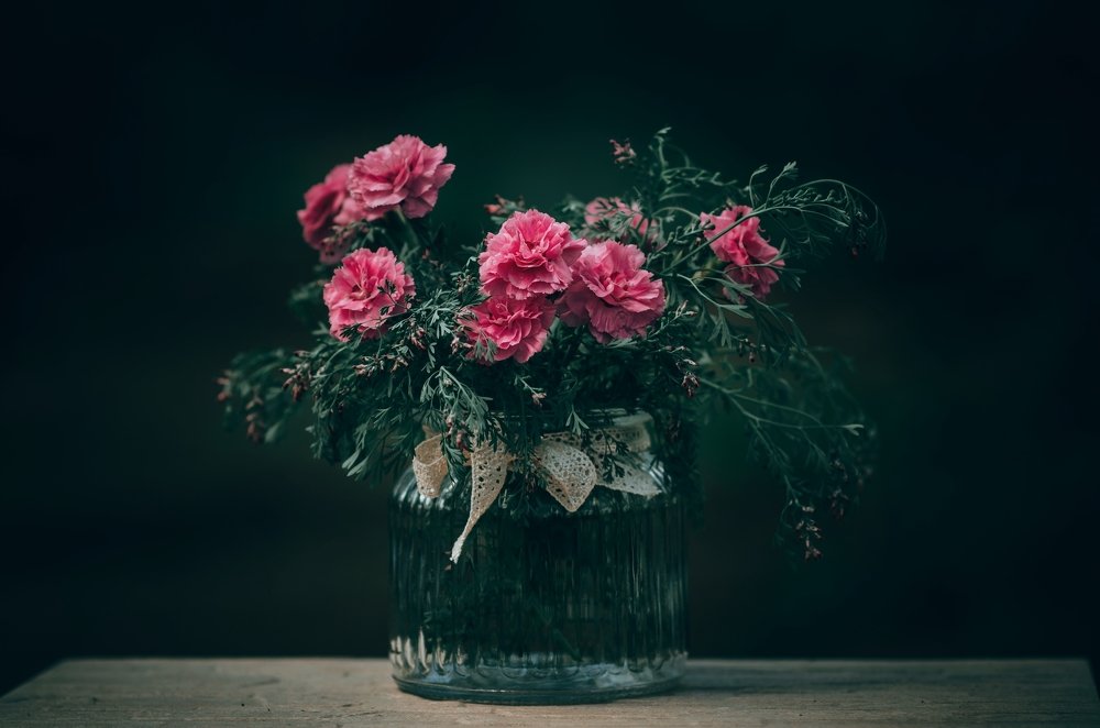 Beautiful bouquet of flowers in vase on blurred background
