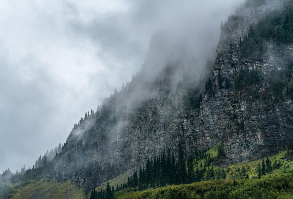 The fog rolls through the mountains on a rainy day