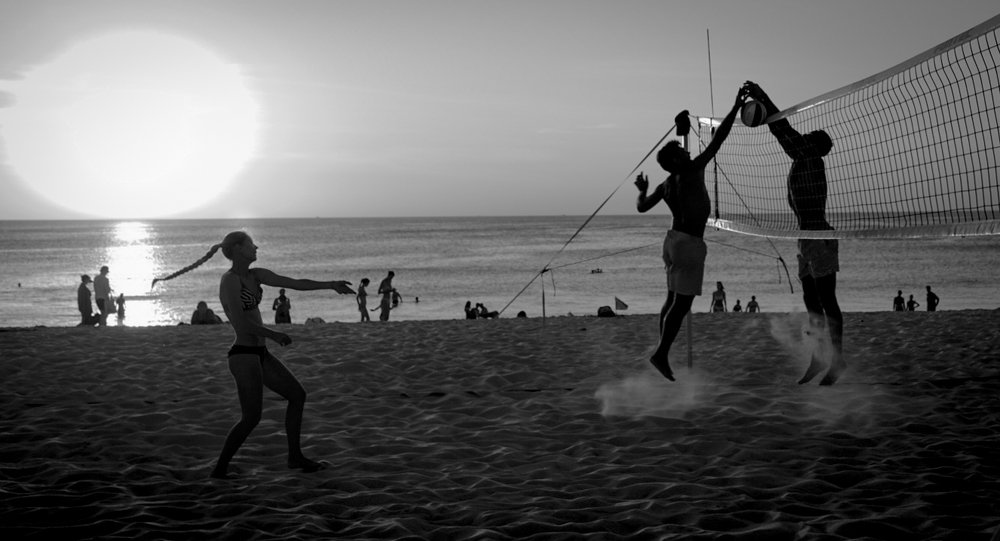 Playing volleyball at sunset. Thailand, Kamala Beach.