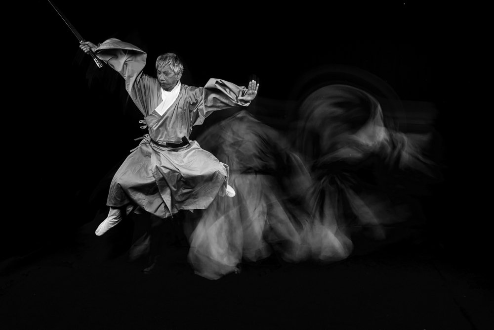 A man jumping with a knife