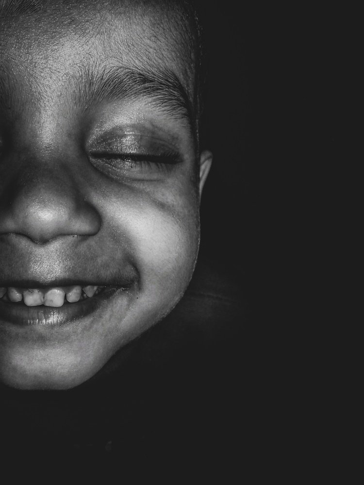 The smile that shines through darkness.