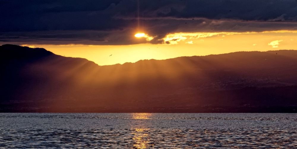 flying on sunset toward Switzerland shore