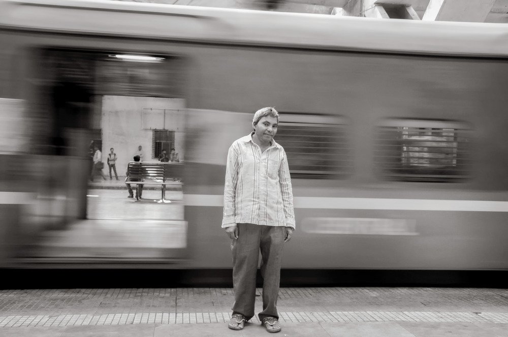 Man standing on local train station.