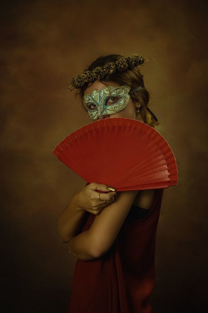 The Owl Woman holding a fan