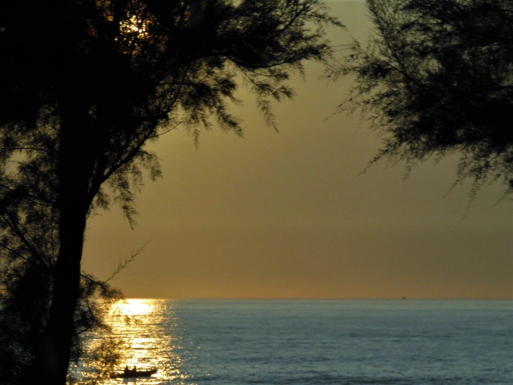 Small boats under golden sunrays